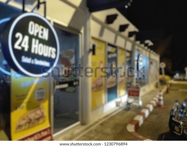 blurry image,Period sign The 24-hour\
food  service is available at the airport parking\
lot.