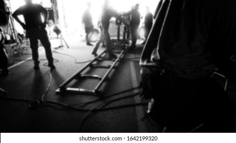 Blurry images of video production camera dolly track at outdoor location setting for shooting movie or film that need smooth and dynamic stable tracking while moving frame shot.