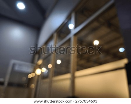 Blurry interior scene with ceiling lights on