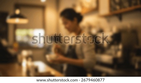Blurry interior view of a cafe worker preparing drinks at a counter.