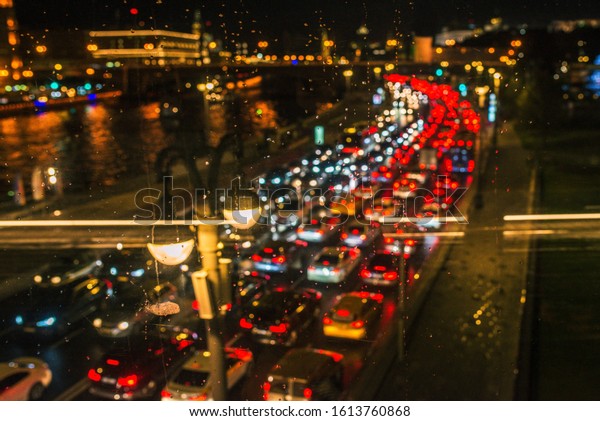 Blurry lights of high traffic cars.\
Traffic on the highway in the city. Glowing\
lights