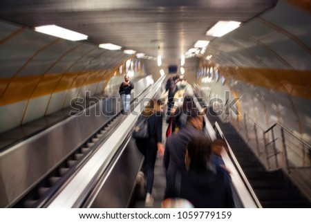 Blurry motion image of people on a escalator in Istanbul subway.
