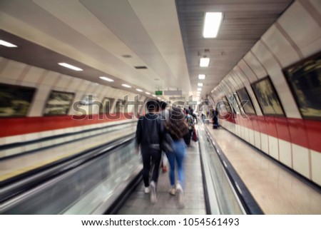 Blurry motion image of people walking in Istanbul subway.
