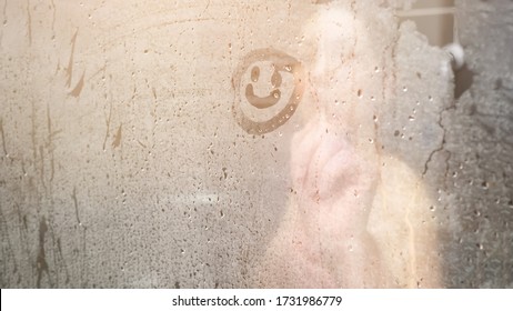 Blurry Naked Lady Draws Smile On White Steam Condensate On Glass-enclosed Shower Door In Bathroom At Home Close View