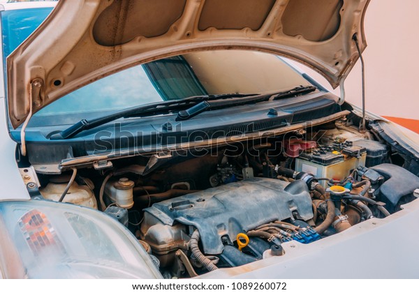 Blurry open hood machine of car on bright daytime\
for repair machine