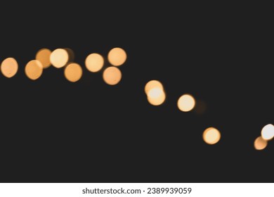 Blurry orange fairy lights glowing in a dark room - Powered by Shutterstock