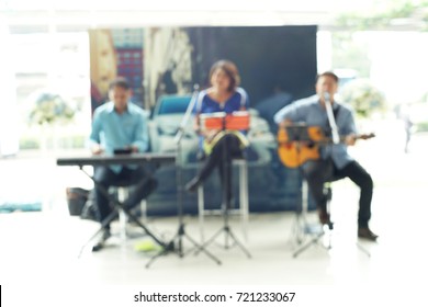 Blurry Photo Of Trio Band With A Guitar Piano And Singing 