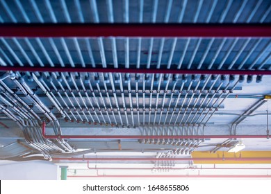 Blurry picture of electrical conduit and cabling. Blurry image for construction background. The rows of electrical conduit and signal cables in the parking building.