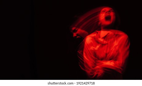 Blurry Portrait Of A Psychopathic Girl With Schizophrenic Mental Disorders On A Dark Background