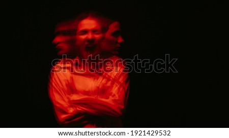 blurry portrait of a schizophrenic woman with paranoid disorders and bipolar disease on a dark background