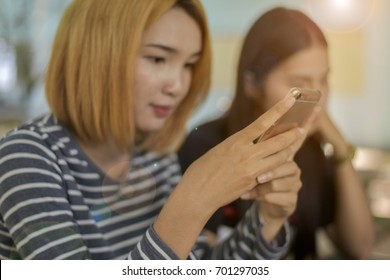 Blurry Pretty Teenage Girls Using Laptop Computer In Garden Park. Digital Device Using  Social Lifestyle Teenager Uncontrolled. Social Distance Lockdown Curfew And Work From Home Concept.