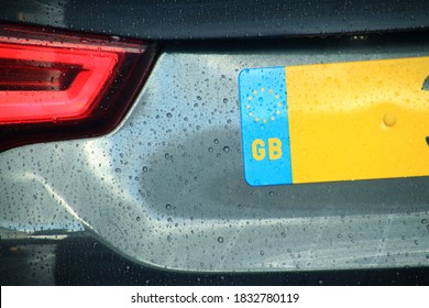 Blurry Rain On The Vehicle And Great Britain Number Plate, License For Car With The European Union Symbol.