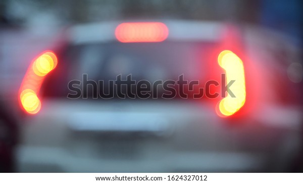 Blurry red brake\
lights of a car unique\
photo