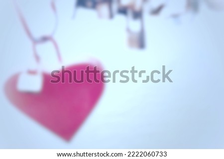Blurry refocused pink heart on blurred background from a refocused photo with vignette and with space for runaround or wraparound text 
