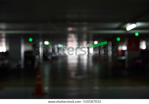 Blurry scene of indoor car parking with\
Blurred light bokeh for abstract\
background