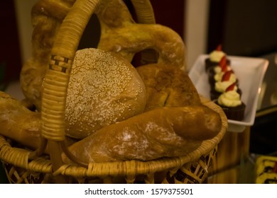 BLURRY and selective focus images of assorted breads put on the traditional bamboo basket.