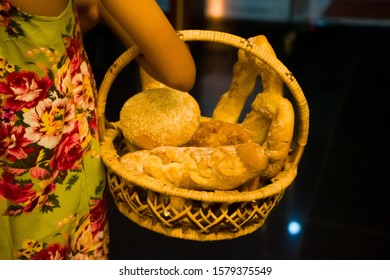 BLURRY and selective focus images of assorted breads put on the traditional bamboo basket.