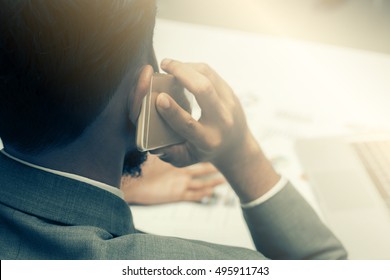 Blurry Serious And Depressed  Business Man Making A Phone Call With Smartphone.Dramatic Moment.Split Tone Instagram Like.With Hot Light Processed