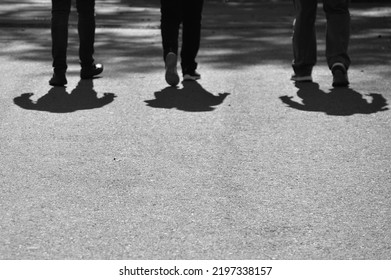 Blurry Shadows Of People Walking On The City Sidewalk In Black And White