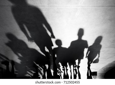 Blurry shadows silhouette of people walking towards the camera on black and white - Powered by Shutterstock