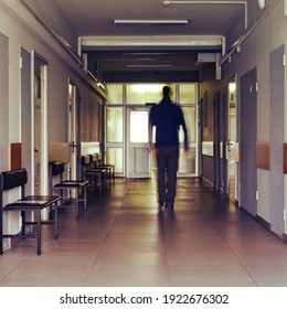 A blurry silhouette of a man leaving a clinic or hospital. Concept of recovery and the end of the coronavirus pandemic - Powered by Shutterstock