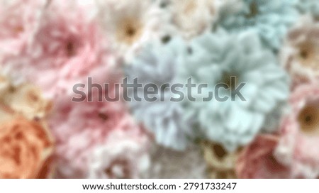 A blurry soft focus background featuring a variety of pastel colored flowers including pink blue and orange blossoms