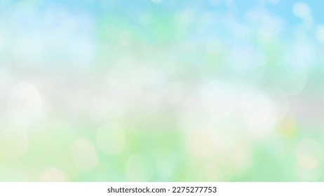 Blurry spring summer abstract background with bokeh lights. Natural blurred morning or day landscape with defocused sun lights on blue green background.