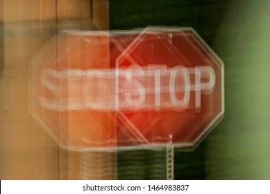 A Blurry Stop Sign Seen Through Impaired Vision Or Distorted Perceptions.