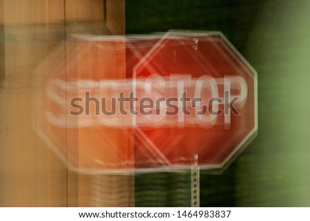 A blurry stop sign seen through impaired vision or distorted perceptions.