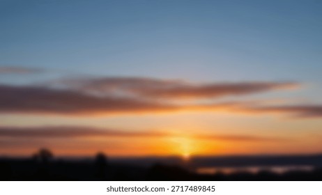 Blurry Sunset over Lake with Dramatic Clouds and Vibrant Orange and Blue Sky.