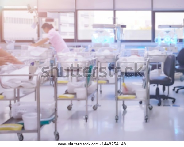 Blurry unidentified new born babies in\
maternity hospital. Newborn and Childbearing center room in modern\
hospital. Newborn in INCU room. Concept new life and Begin and\
start of life,\
Congratulations.