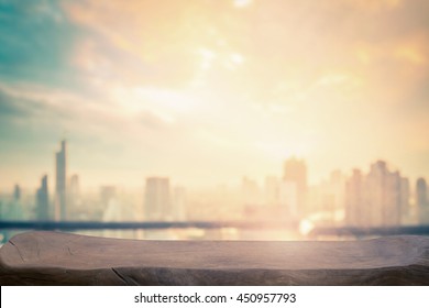 Blurry Urban Wallpaper Concept: Rooftop View Of Wooden Restaurant Table And City Skyline Autumn Sunset Background. Bangkok, Thailand, Asia