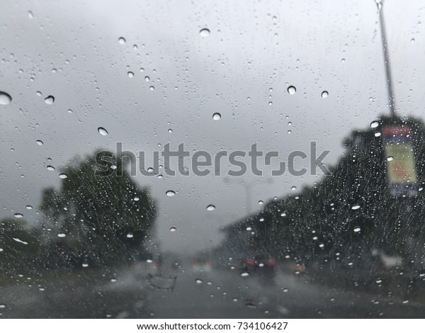 Blurry view\
during raining with road\
background