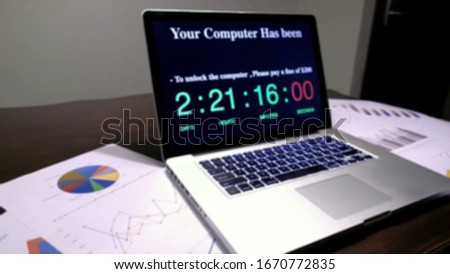 Blurry view of Hackers using adware fireball to control laptop computer using web browser search engine to spy and steal information. Internet security cyber attack hijack concept.