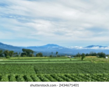 Blurry view of mountains and fields
