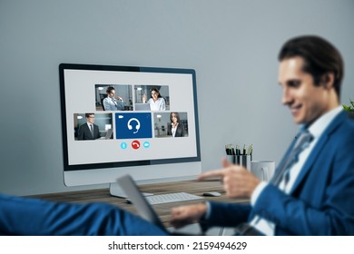 Blurry young european businessman using laptop computer with creative video conference call on screen. Work, home and remote team concept - Shutterstock ID 2159494629