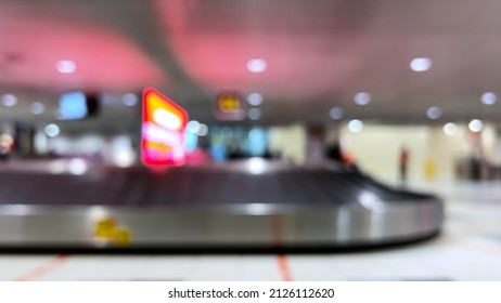 Blury Empty Baggage Carousel In The Airport Terminal. Flight Arrival. Conveyor Belt Claim Unloading Luggage. International Traveling. 