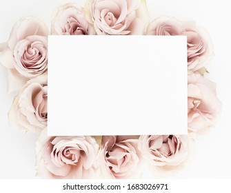 Blush roses floral flat lay with blank stationery card