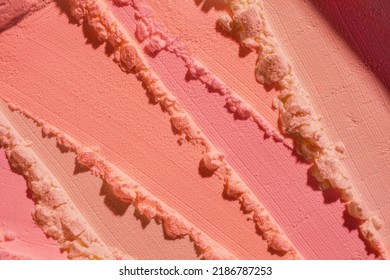Blusher or pressed powder pink orange peach textured background 庫存照片