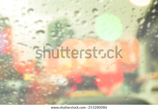 bluured of
raindrops on window at night in the
city