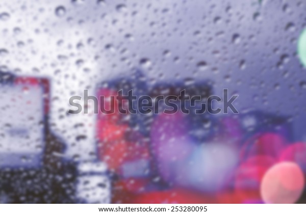 bluured of\
raindrops on window at night in the\
city