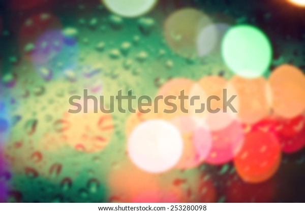 bluured of\
raindrops on window at night in the\
city
