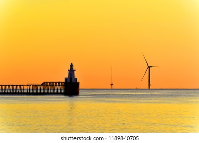 Blyth Northumberland Lighthouse Wind Turbine And Met Mast SeaRoc During A Golden Dawn