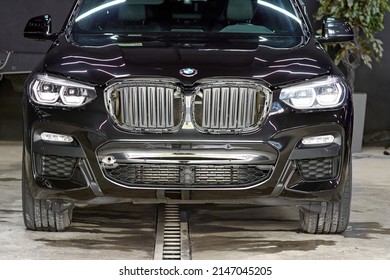 The BMW Car, Covered With A Protective Shiny Black Paint Film, Is In A Repair Shop. PPF Polyurethane Film Protects Car Paint From Stones And Scratches, Blurred Focus. Chelyabinsk, Russia, May 07, 2021