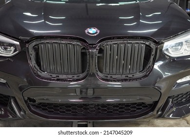 The BMW Car, Covered With A Protective Shiny Black Paint Film, Is In A Repair Shop. PPF Polyurethane Film Protects Car Paint From Stones And Scratches, Blurred Focus. Chelyabinsk, Russia, May 07, 2021