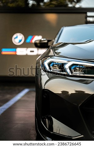A BMW car is seen on display at a dealership surrounded by other BMW vehicles in the background
