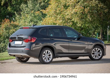 BMW X1 2012 Year R18 Wheels Is A Compact Sport Utility Vehicle. Black Color. Beautiful Sunny Background.