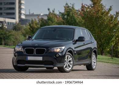 BMW X1 2012 Year R18 Wheels Is A Compact Sport Utility Vehicle. Black Color. Beautiful Sunny Background.