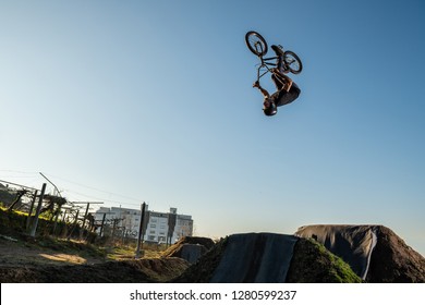 BMX Bike Back Flip Jump On A Dirt Track.