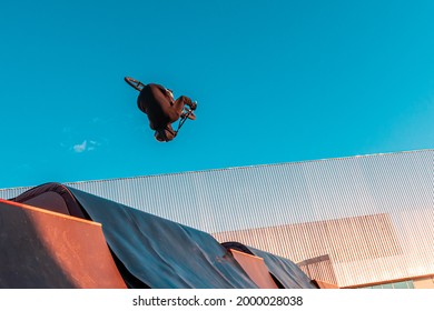 Bmx rider doing trick on ramp in skate park. Sports, extreme sports, freestyle, the concept of outdoor activity.